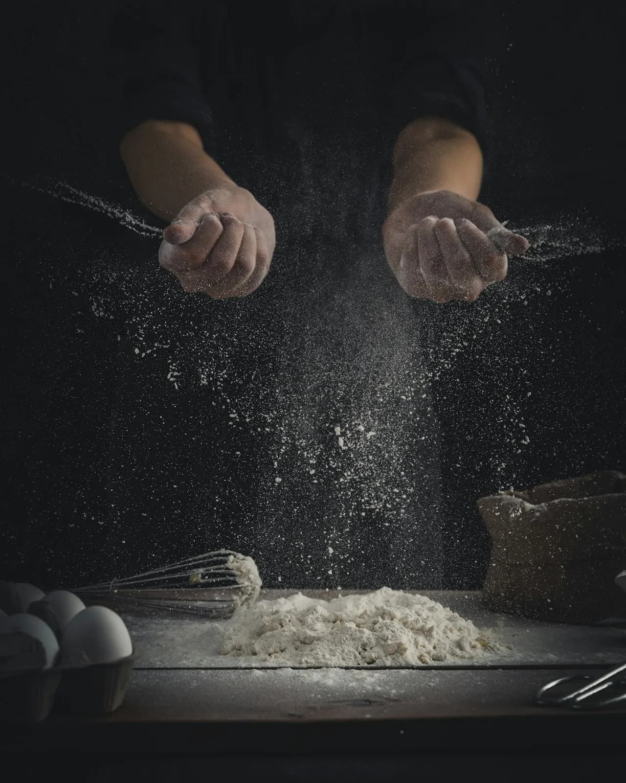 Icing sugar being dusted by hand