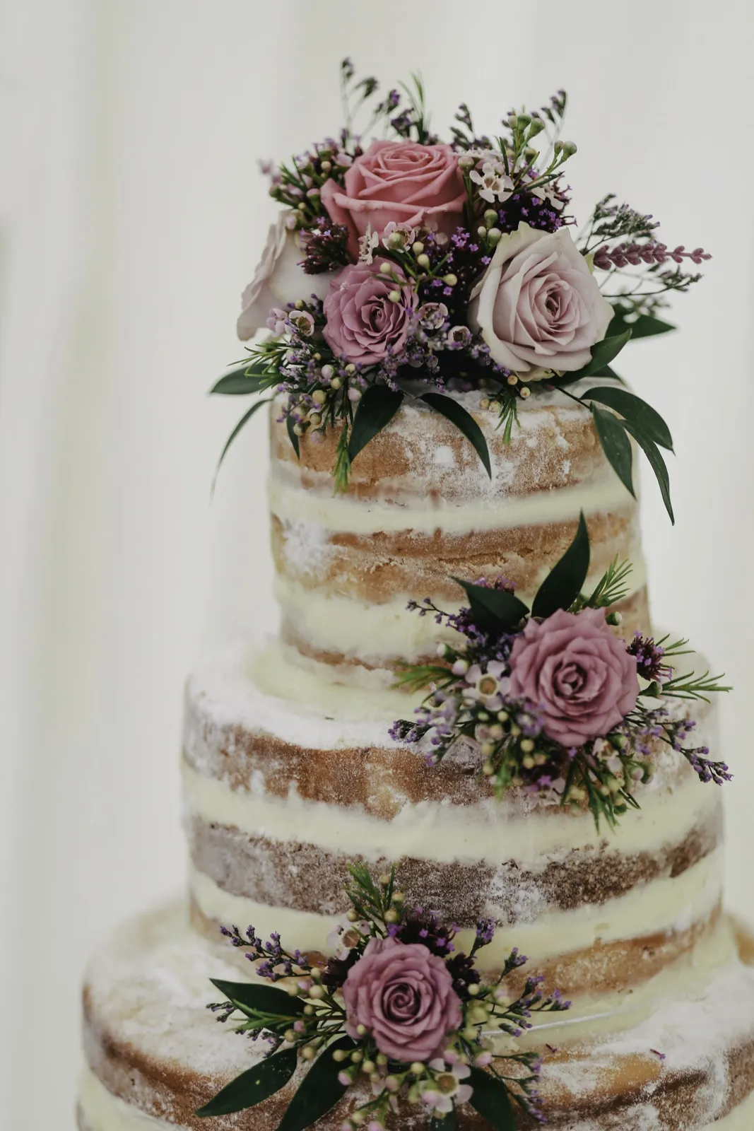 Semi-naked wedding cake with fresh roses